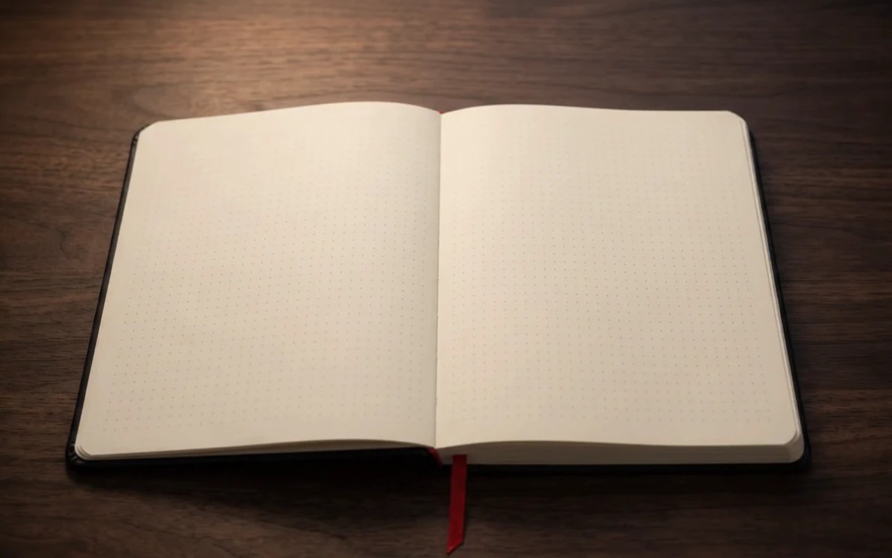 The notebook open on its dot grid, a quick pen sketch of an app board on the right page